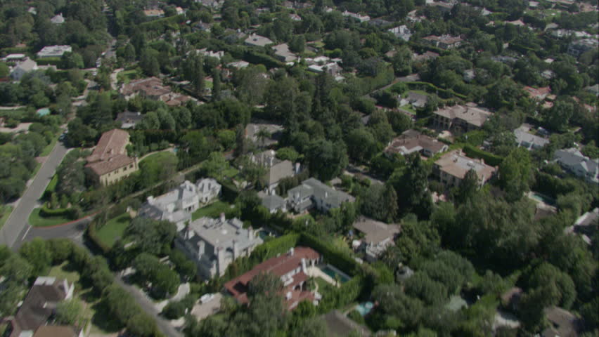 aerial flying shot over luxurious suburban area, streets, and golf course circa 2009