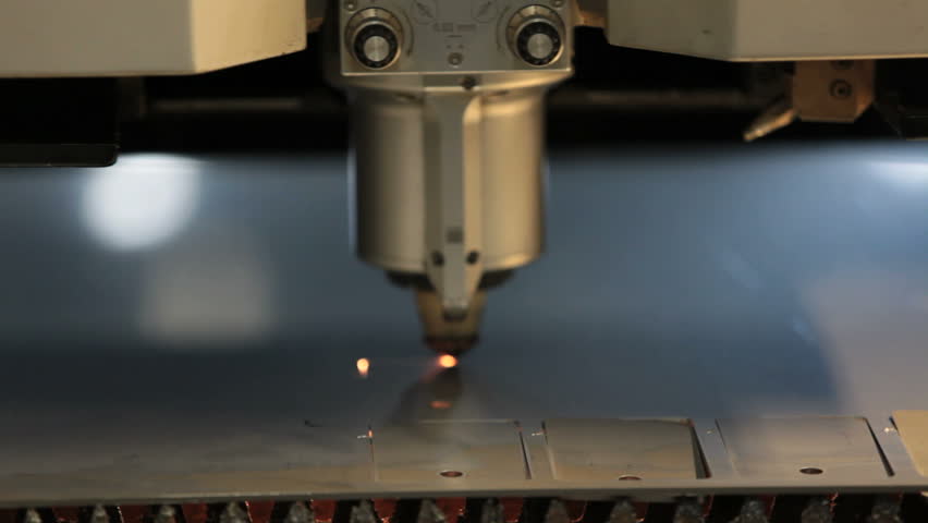 Industrial robotic laser cutter cuts metal parts with great precision just like a knife through butter