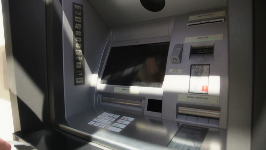 Man getting money from ATM