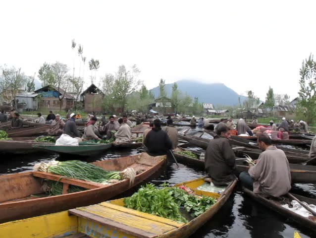 SRINAGAR, INDIA - APRIL 14: Kashmiri men sell their vegetables at a floating market in the early hours before sunrise on April 14, 2012 in Dal Lake, Srinagar, Jammu and Kashmir, India. 