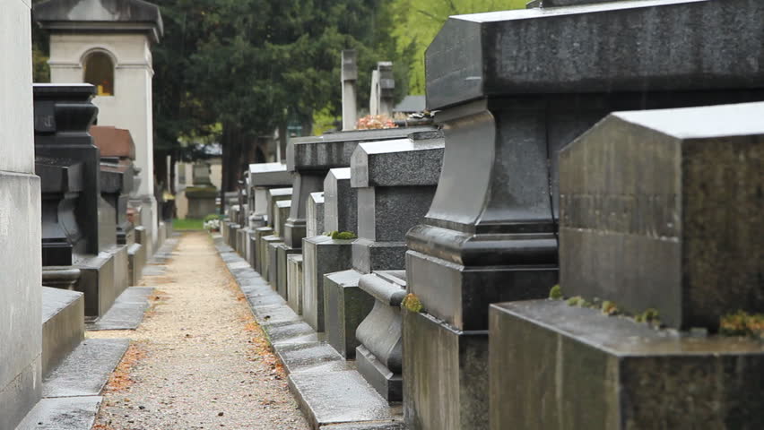 French cemetery in the rain. 
Rain falling and dripping from burial monuments. Montparnasse cemetery, Paris, France. 
