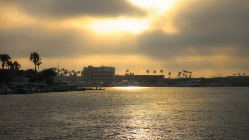 Ocean harbor with setting sun glistening off the water