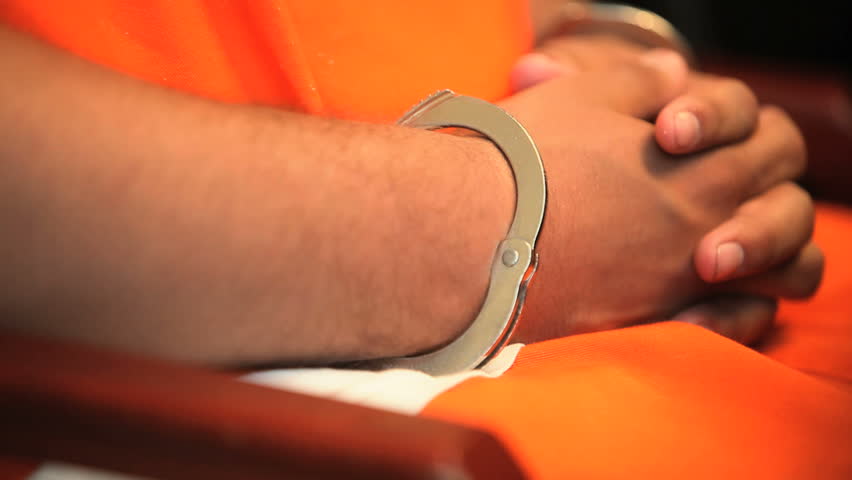 Deputy checking the handcuffs on a prisoner