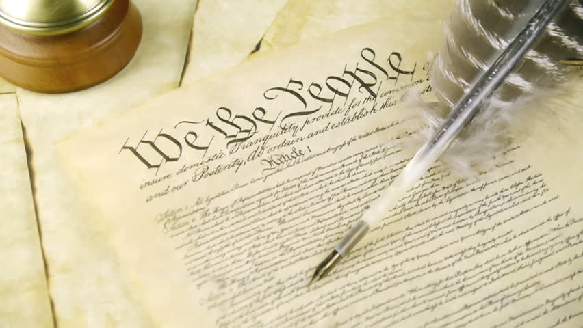 US Constitution Tilt Up (HD). US constitution parchment with feather quill shown with a slow up tilt movement.