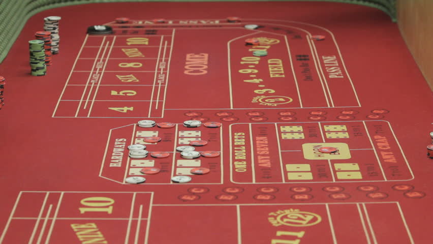 Gambler tossing dice onto the crap table