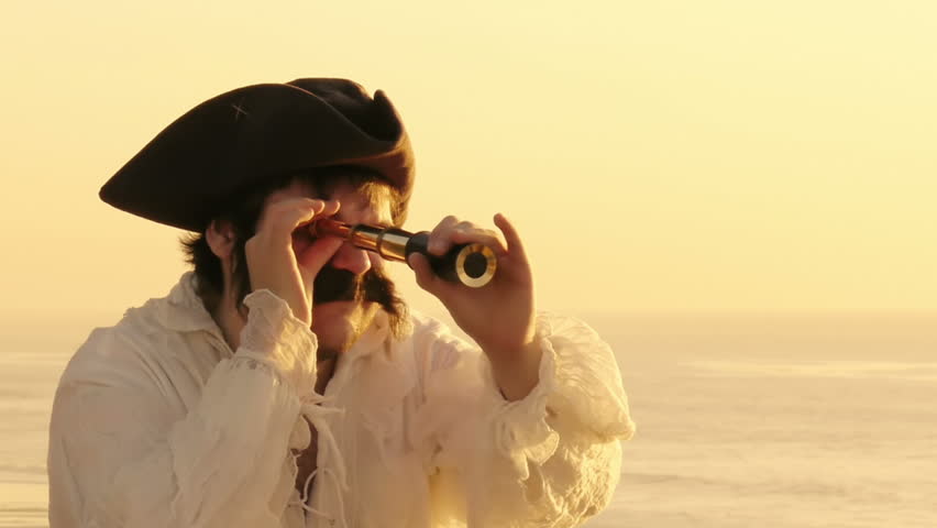 Sailor Looking Thru Spyglass (HD). Pirate sailor with white shirt looking at the ocean horizon with a spyglass at sunset. 