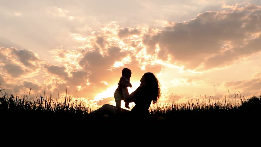 Silhouettes mother and baby sunset