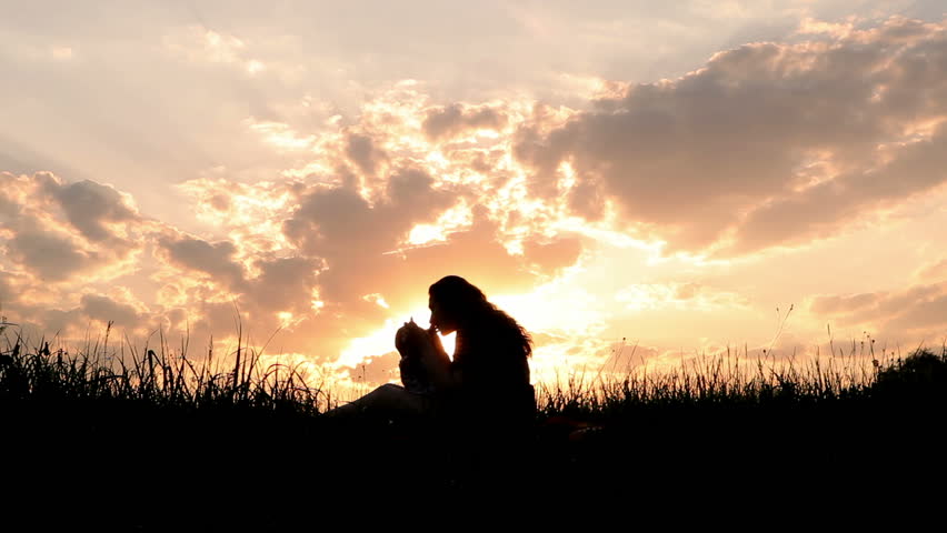 Silhouettes mother and baby sunset.?oncept of harmony.