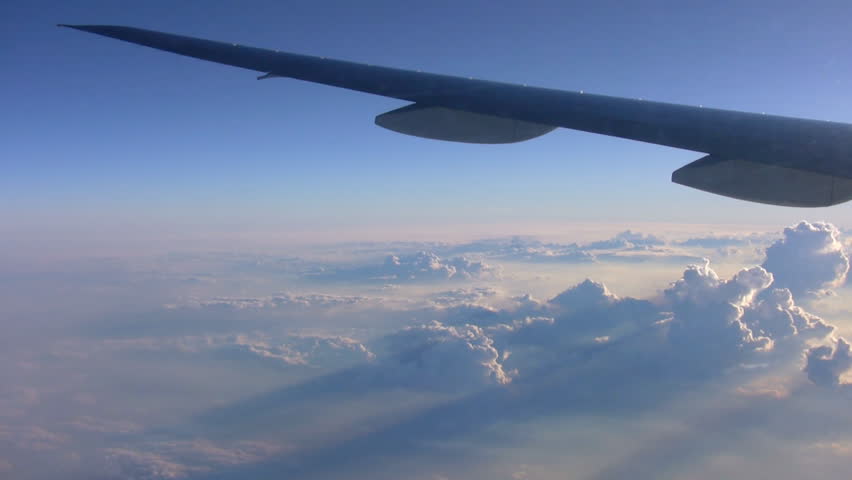 View of clouds above the Coral Sea from aircraft. Some small smears and reflections from the window. Canon HV20, 1080-50i.