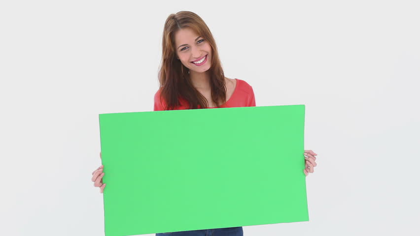 Beautiful woman holding a blank poster against white background