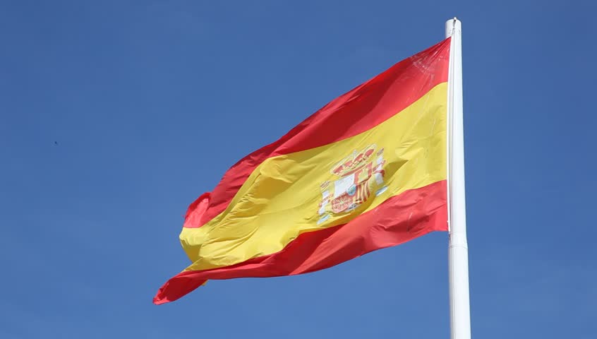 Spanish national flag against a blue sky