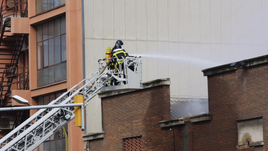 firemen hose down fire in barcelona