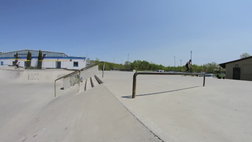 BMXer does a Grind to Barspin in Skatepark