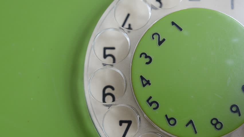Old green rotary phone close up