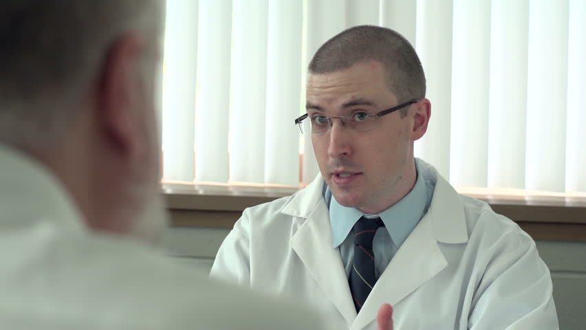 Doctor talking with patient in his office