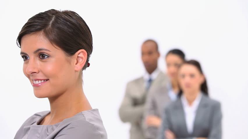 Businesswoman with colleagues against a white background
