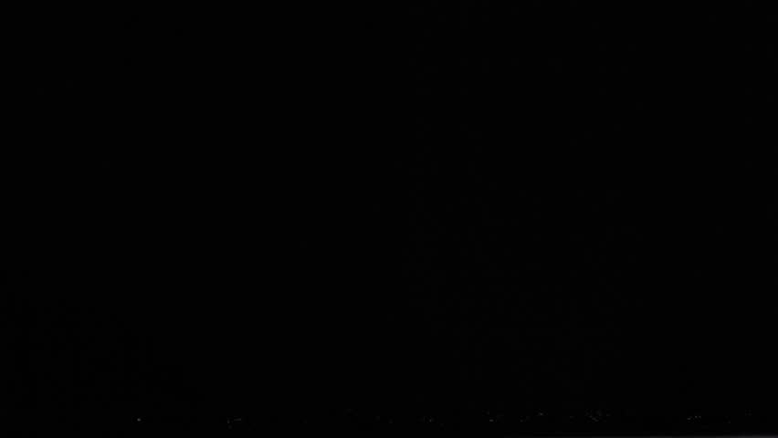 Three plastic bottles in a super slow motion falling against a black background