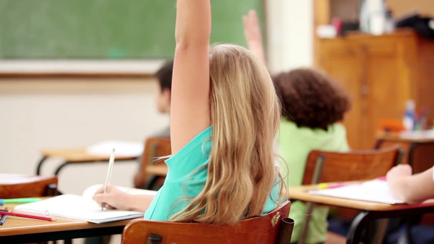 Happy pupils raising their fingers in the classroom
