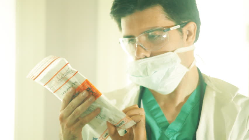 Doctor looking at a bio hazard specimen bag