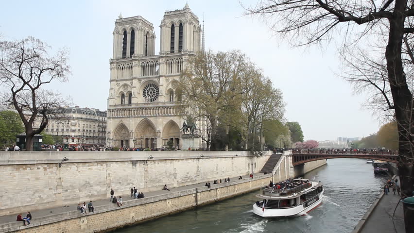PARIS, FRANCE APRIL 8th: Notre Dame Cathedral with tour boat passing on April 8th, 2012 in Paris. Notre Dame is the cathedral of the Catholic Archdiocese of Paris.