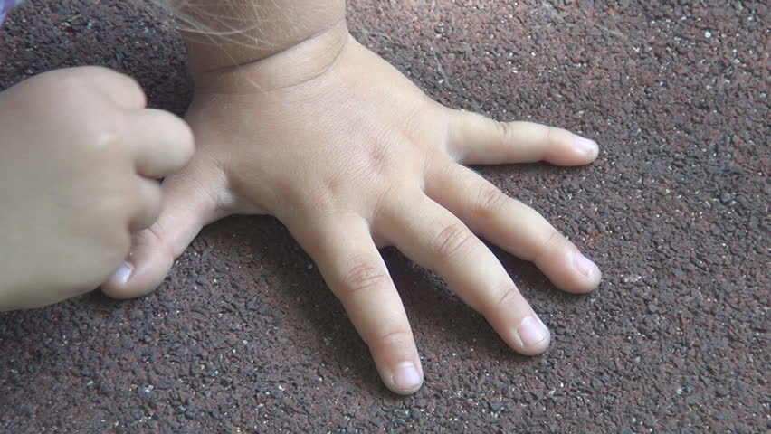 Little girl tracing hand with chalk