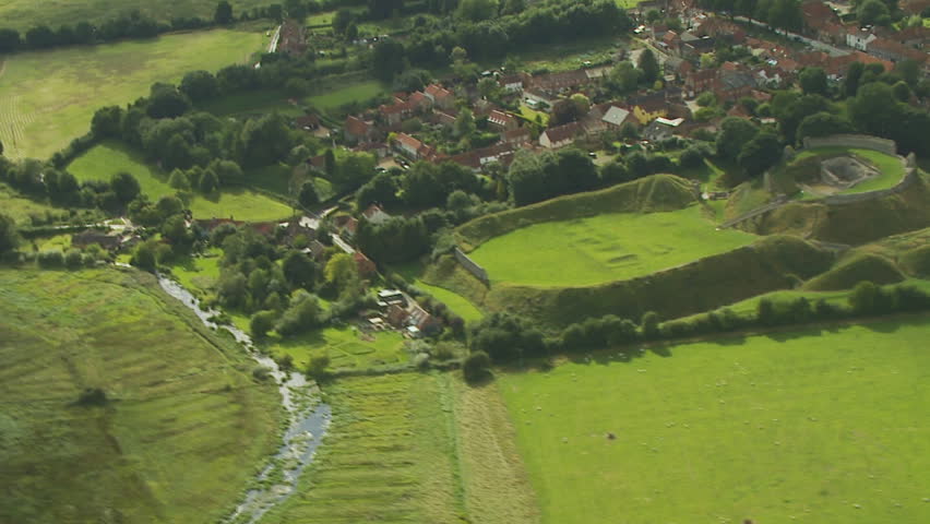 Aerial view of castle ruins and river in England. No audio.