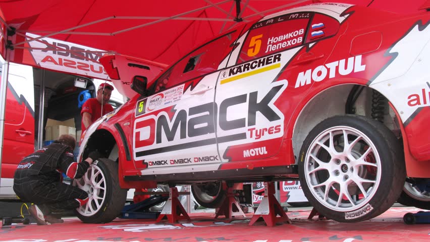 MOSCOW - APR 21: (Timelapse View) Automobile mechanic establishes wheel on car of team ALM RUSSIA before start, on Rally Masters Show, on April 29, 2012 in Moscow, Russia
