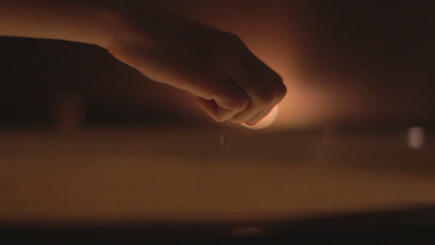 Hand pours salt into a therapeutic bath