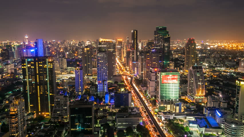BANGKOK - JUNE 24, 2012: Timelapse view on Sathorn street of skyline at night on June 24, 2012 in Bangkok, Thailand.