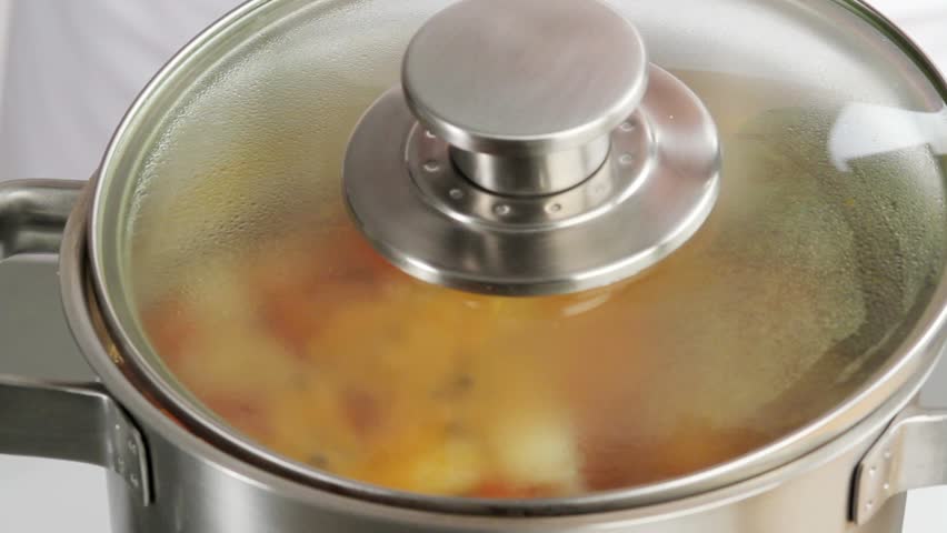 Skimming scum from the surface of vegetable stock