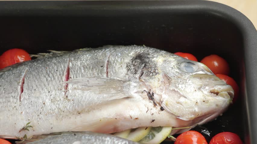 Brushing seabream with herb oil