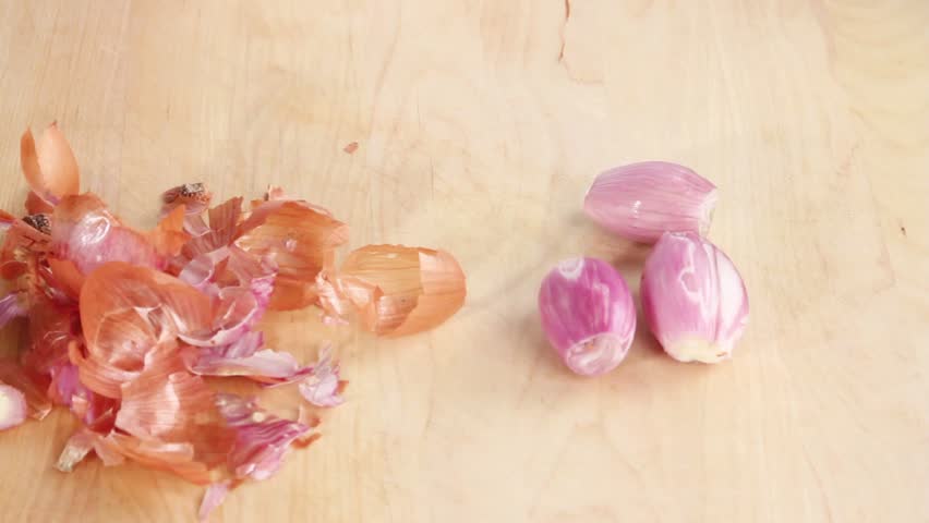 Peeled shallots being halved