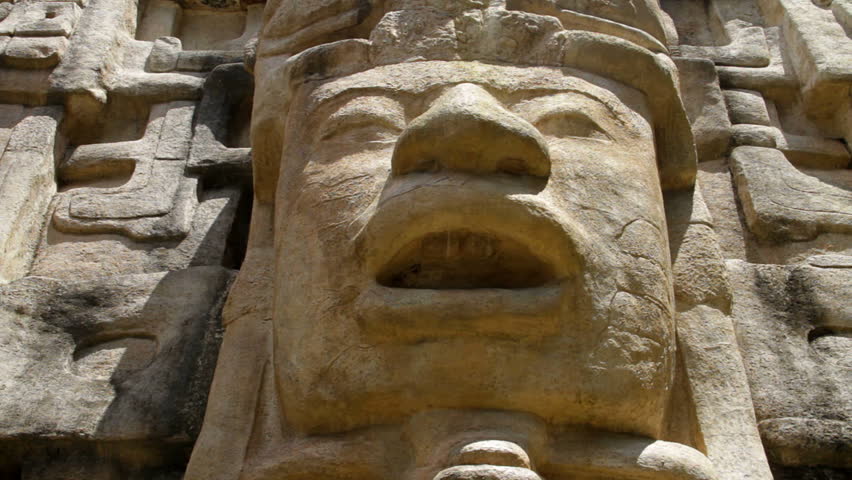 Pan of a face on a Mayan Temple in Lamanai ("submerged crocodile") in Belize