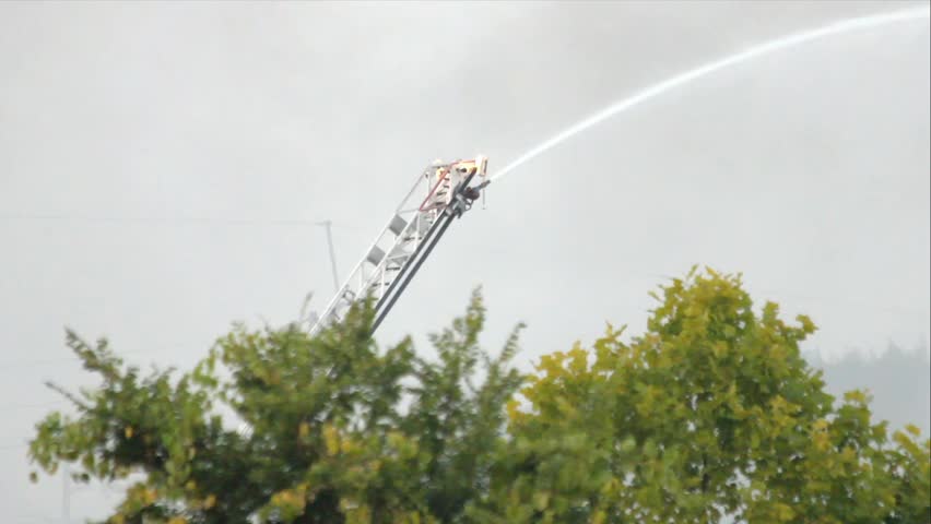 Remote Control Water Cannon On Tall Ladder Spraying Stream Of Water