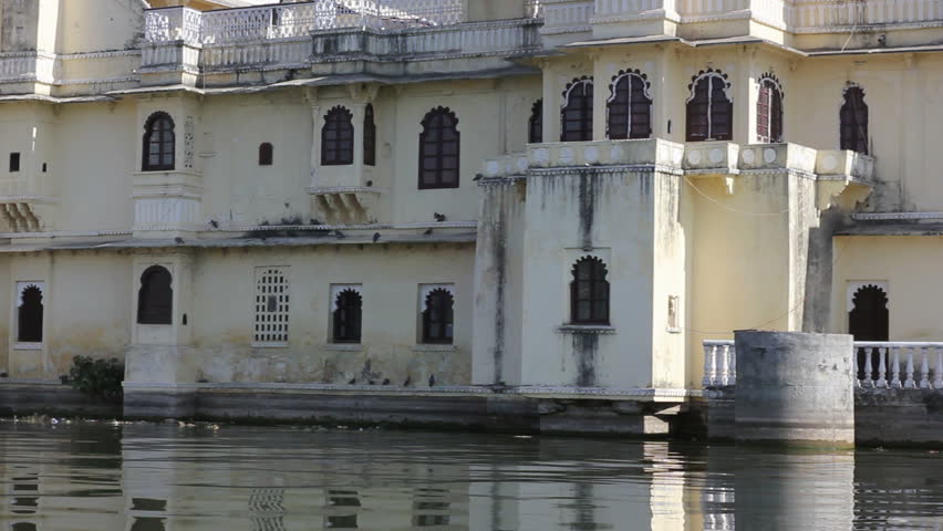 UDAIPUR, INDIA - JANUARY 7: Local people bath and do their laundry at the edge of lake Pichola on January 7, 2011 in the city of Udaipur, Rajasthan, India. Lake Pichola is alake which was built in the 15th century. 