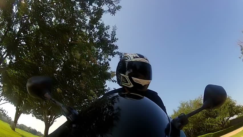 Point of view from a camera attached to the front fender of the motorcycle up to the motorcyclist.