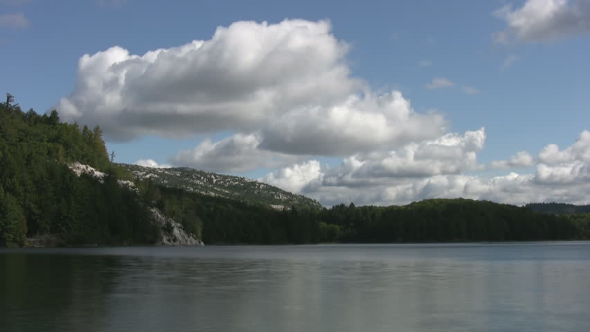 Timelapse clouds move over Norway Lake, Killarney Provincial Park, Ontario, Canada.