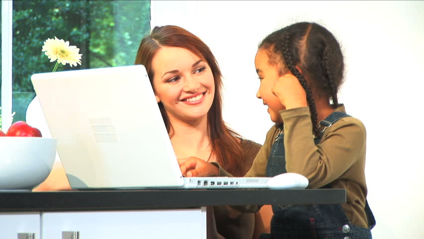 Beautiful Woman and Cute Child Using Laptop Computer