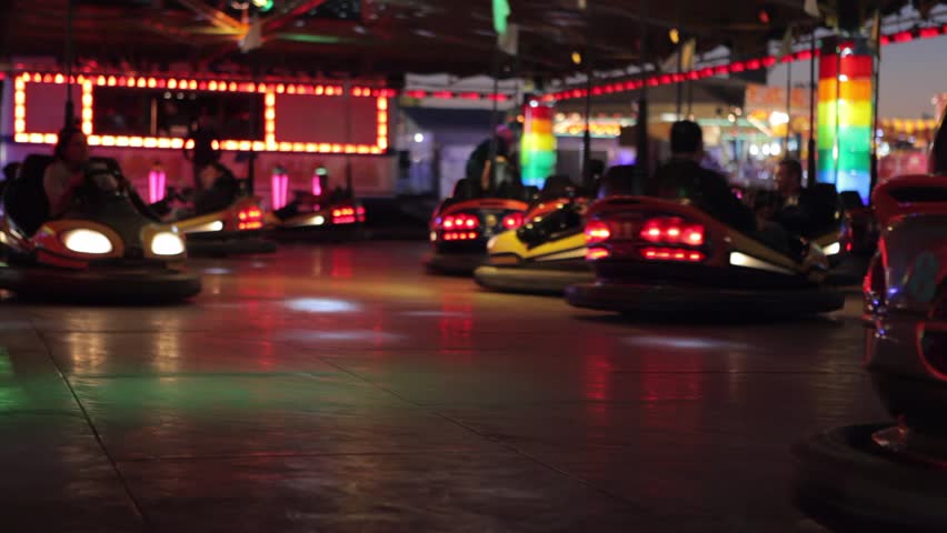 Bumper cars ride at a fun fair at night.