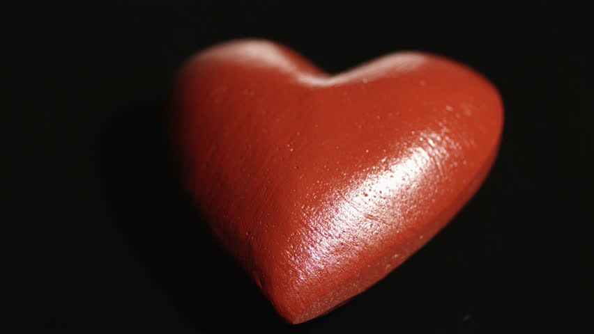 hammer breaking red heart on black background