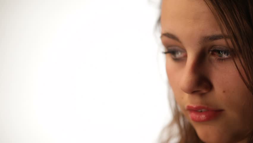 Half face of sad beautiful young woman isolated