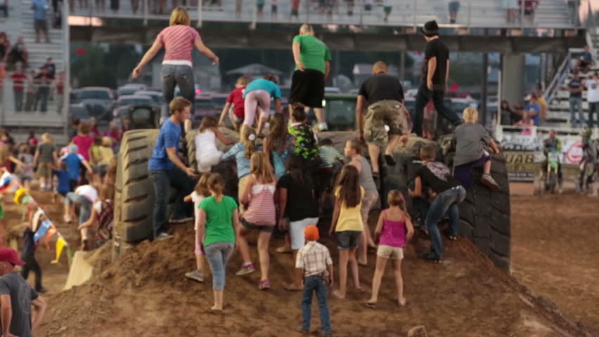 NEPHI, JUAB, UTAH JUN 2012: Obstacle course people climb tires during invitational fun run. Economic boost to rural community. Juab County extreme enduro.
