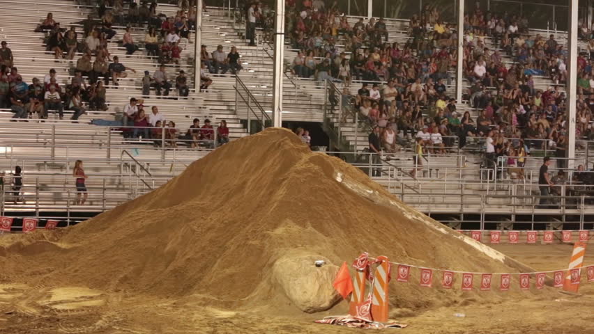 NEPHI, JUAB, UTAH JUN 2012: Motorcycle crash sand hill motorcross race. Juab County extreme enduro. Amateur and pro level riders ride an obstacle course. Spectators watching from stands.