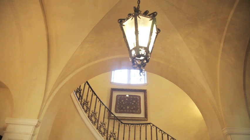 Shot panning down from the top of a winding staircase
