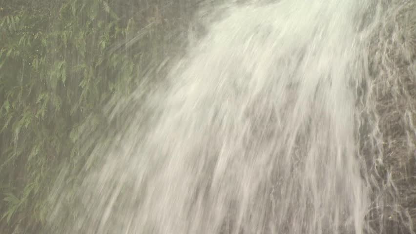 Close Up Of Al Waterfall And Surrounding Greenery