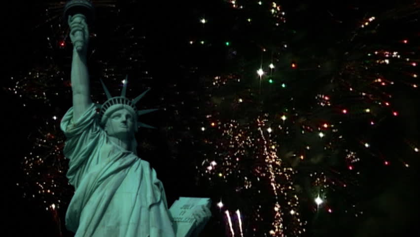 Statue of Liberty with fireworks in the background.