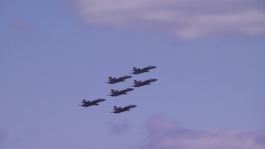 QUONSET, RHODE ISLAND - CIRCA JUNE 2012: Six Blue Angels jets flying past camera and then splitting away in different directions