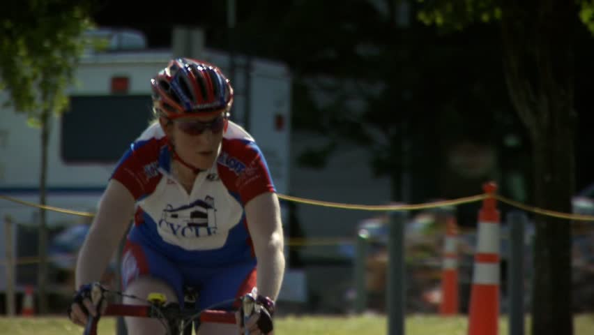 PROVIDENCE, RHODE ISLAND - SEPTEMBER 3, 2009: Woman bicycle racer passing camera - slow motion