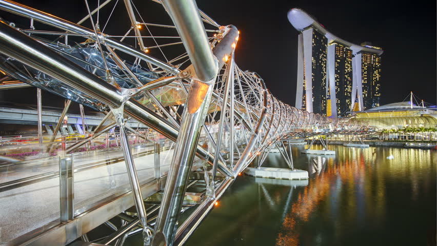 SINGAPORE - CIRCA MAY 2011: People on the illuminated Helix Bridge and Marina Bay Sands Singapore