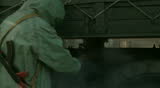 Soldier in overalls disinfecting truck